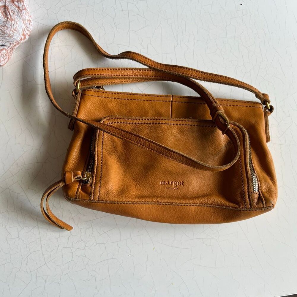 Margot cognac brown leather crossbody bag with dual front slip/zip pockets and a
